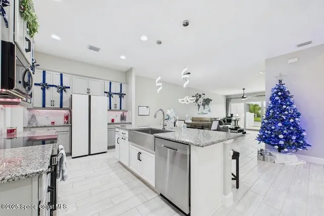 a kitchen with a stove top oven and refrigerator
