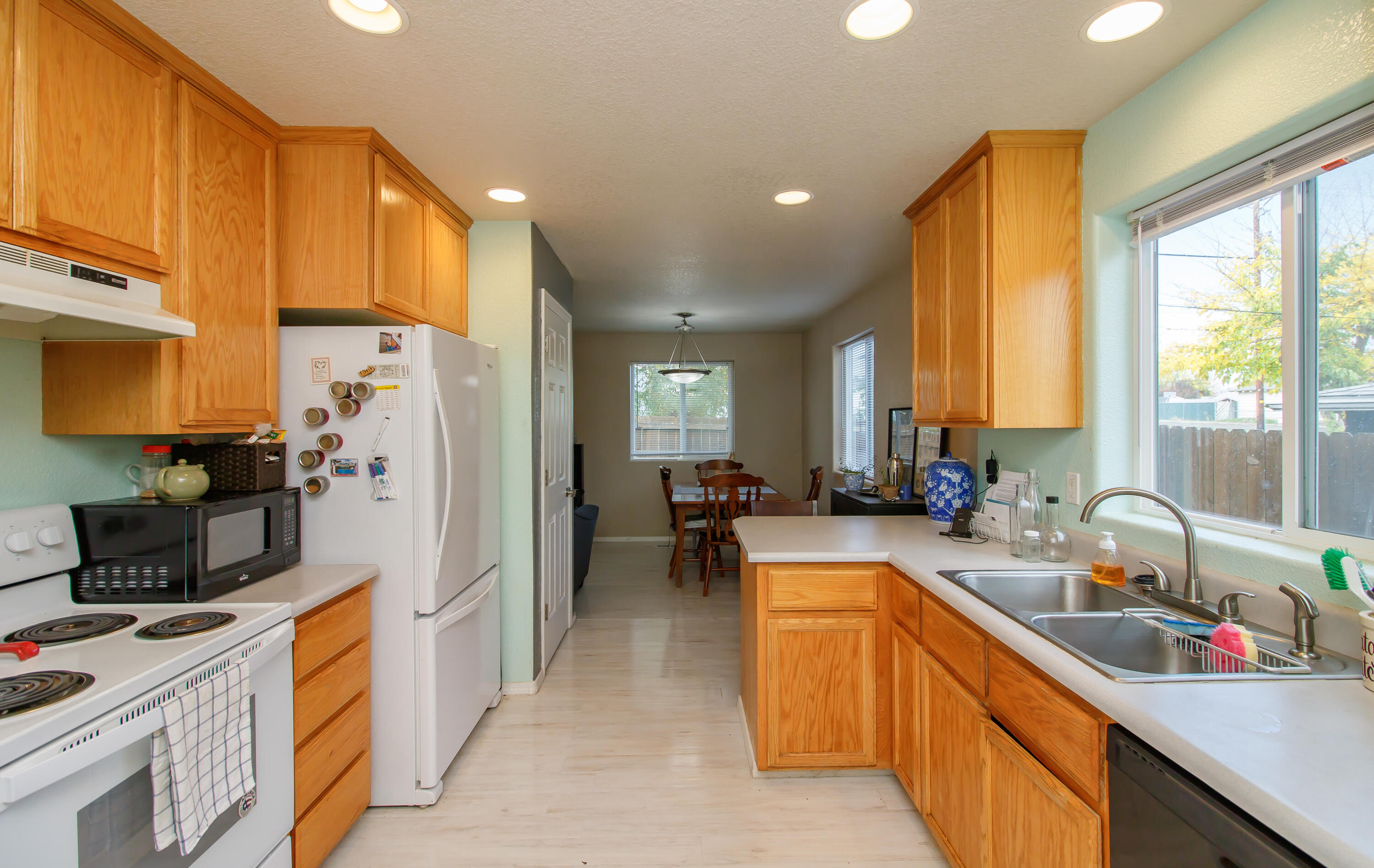 607 Shadow Way Central Point, OR 97502 - Photo 8 of 28 a kitchen with stainless steel appliances a sink a refrigerator and a cabinets