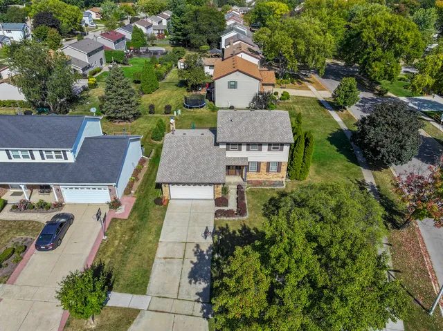an aerial view of a house with a yard