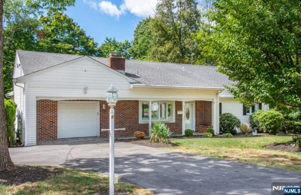 9 Forest Terrace Wayne, NJ 07470 - Photo 1 of 23 a view of a brick house with a yard plants and large tree