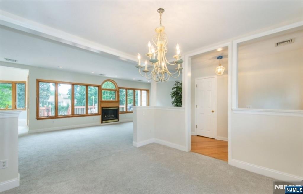 9 Forest Terrace Wayne, NJ 07470 - Photo 4 of 23 a view of a livingroom with a chandelier fireplace and large windows