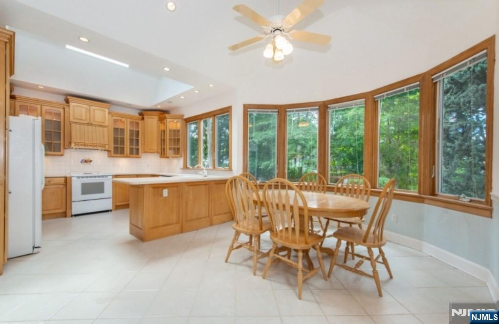 9 Forest Terrace Wayne, NJ 07470 - Photo 9 of 23 a view of a dining room with furniture a chandelier and kitchen view
