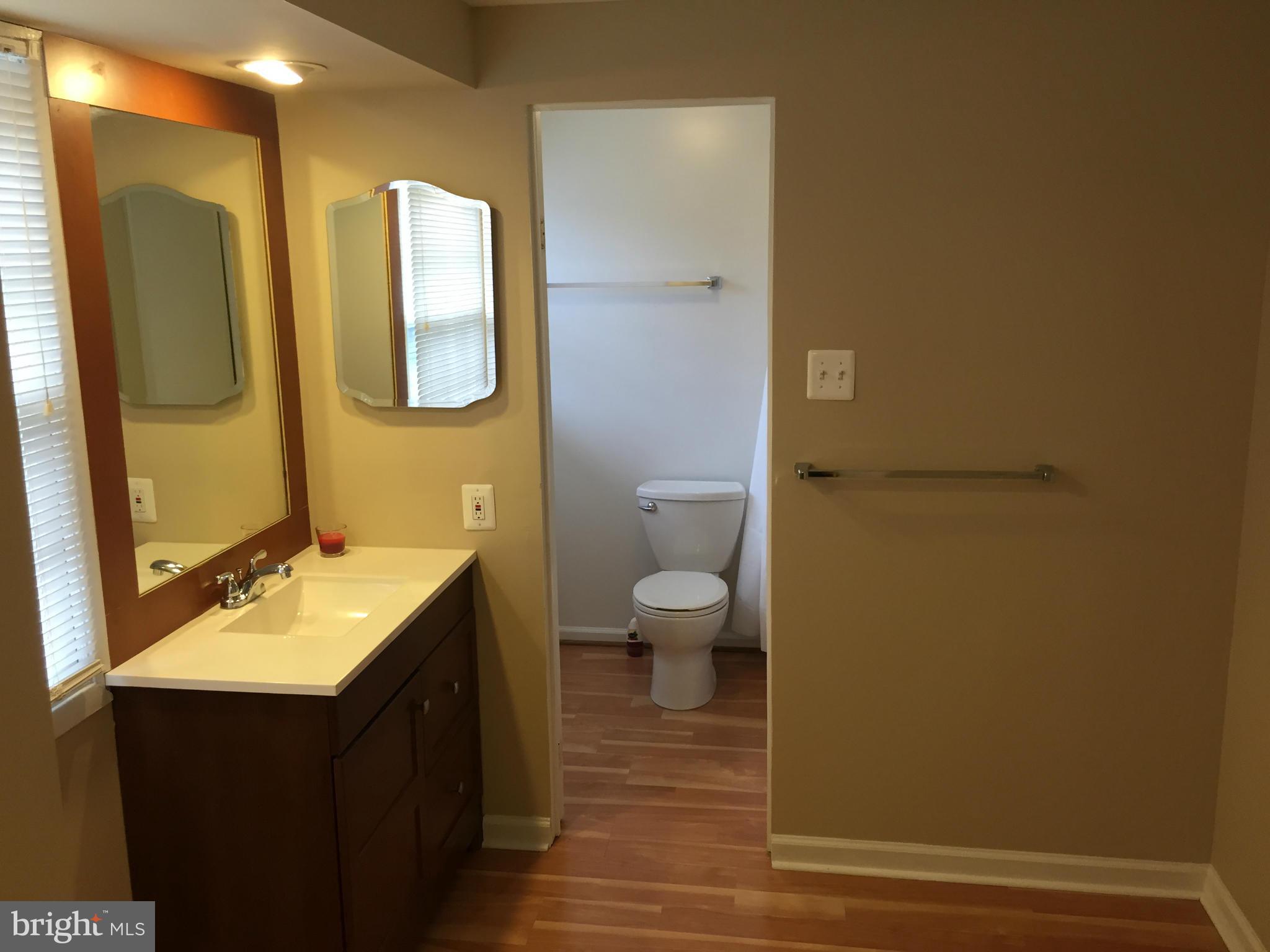 12612 Cedarbrook Lane Laurel, MD 20708 - Photo 2 of 22 a bathroom with a sink and a mirror