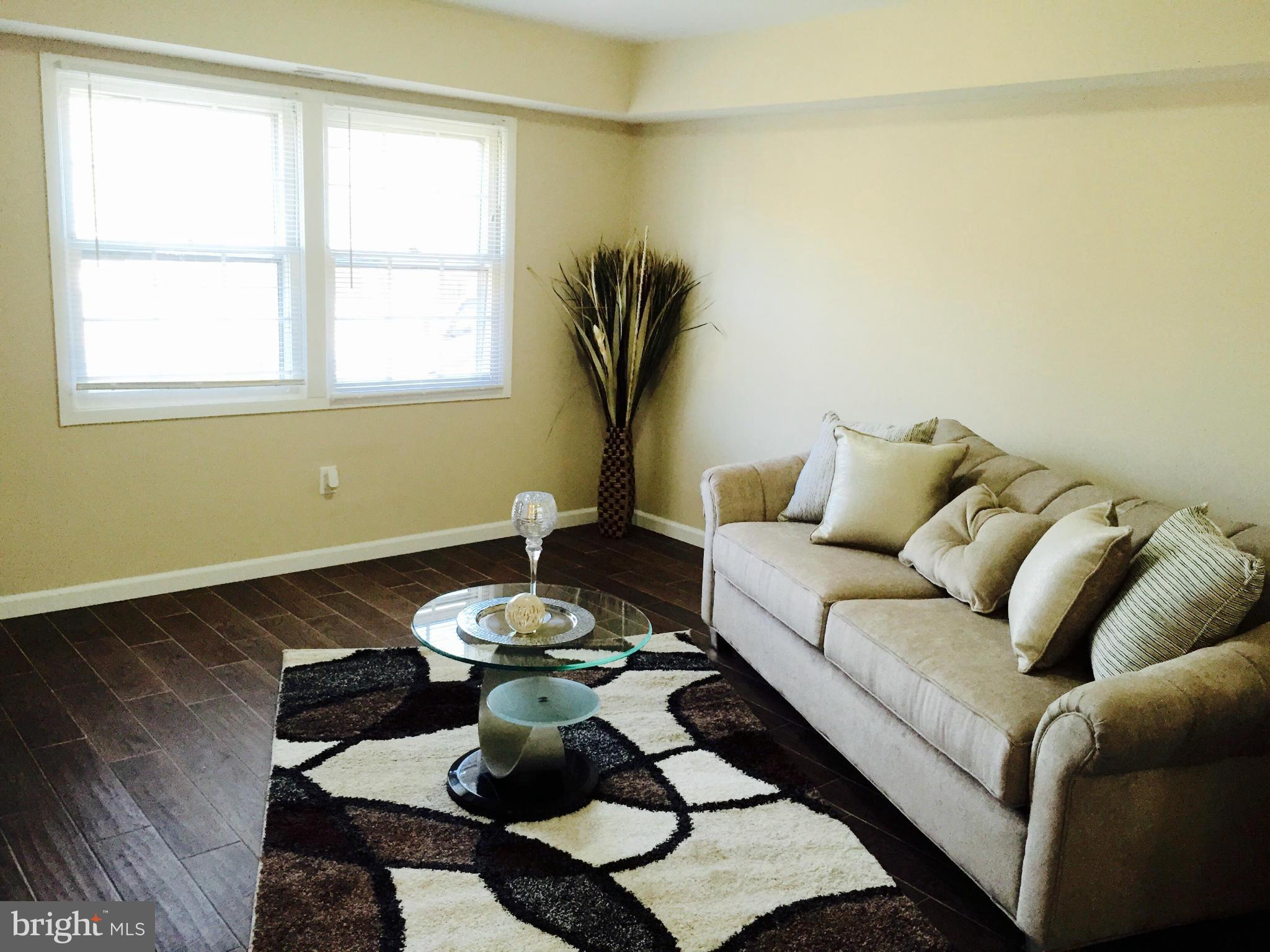12612 Cedarbrook Lane Laurel, MD 20708 - Photo 11 of 22 a living room with furniture and a window