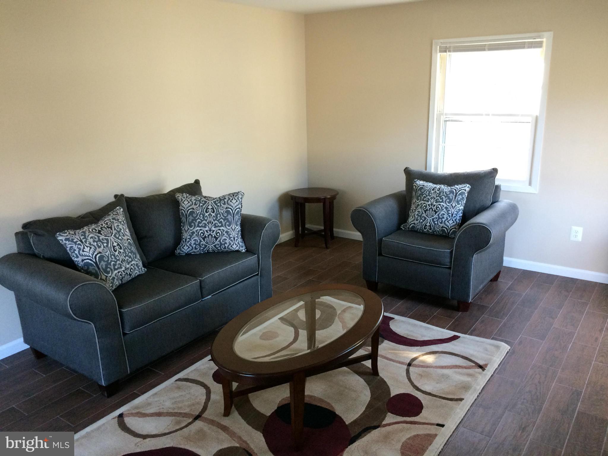 12612 Cedarbrook Lane Laurel, MD 20708 - Photo 13 of 22 a living room with furniture and a window