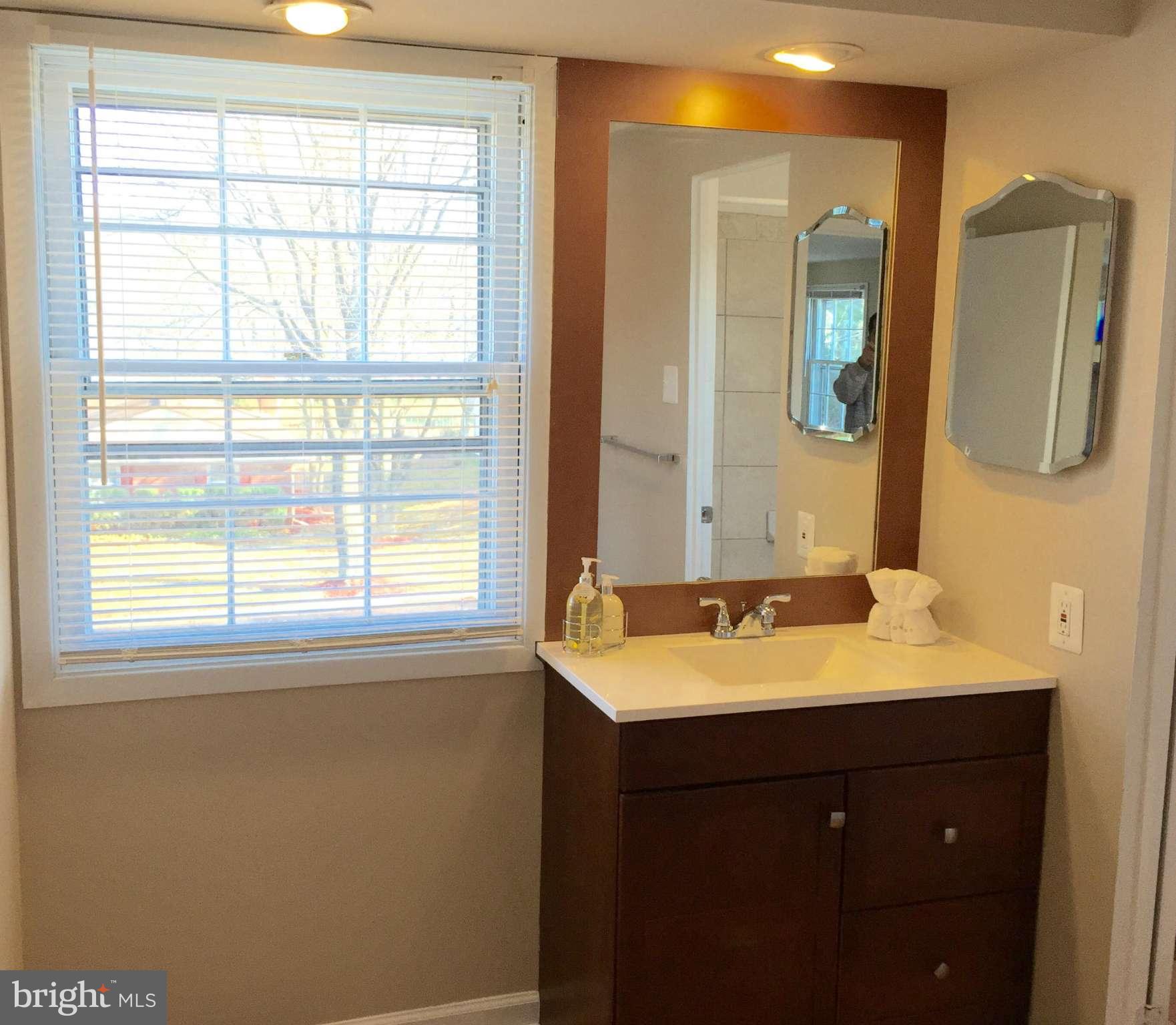 12612 Cedarbrook Lane Laurel, MD 20708 - Photo 20 of 22 a bathroom with a sink and a mirror