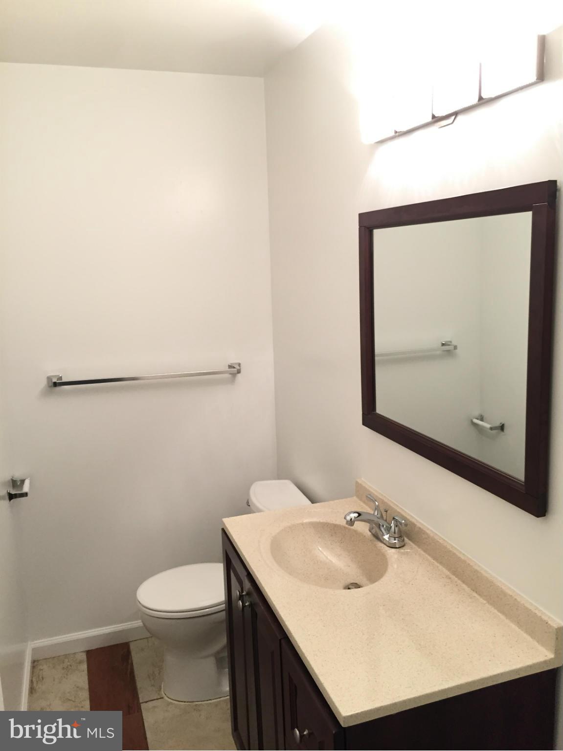 12612 Cedarbrook Lane Laurel, MD 20708 - Photo 3 of 22 a bathroom with a sink toilet and mirror