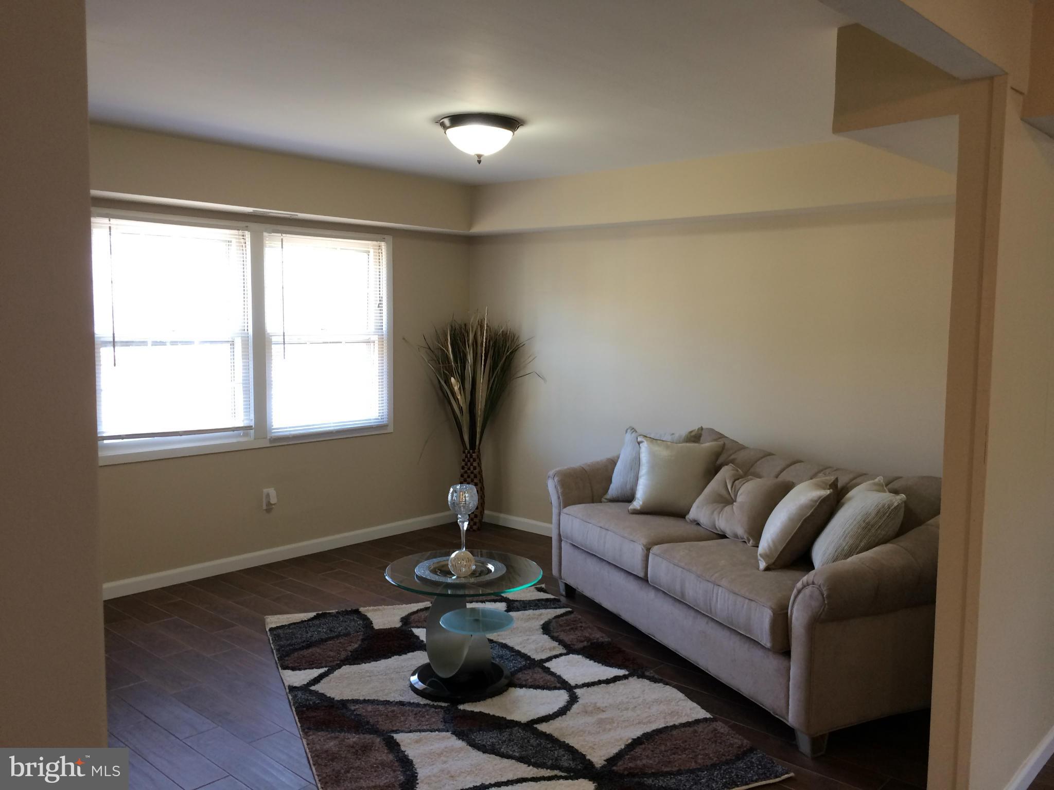12612 Cedarbrook Lane Laurel, MD 20708 - Photo 22 of 22 a living room with furniture and a window