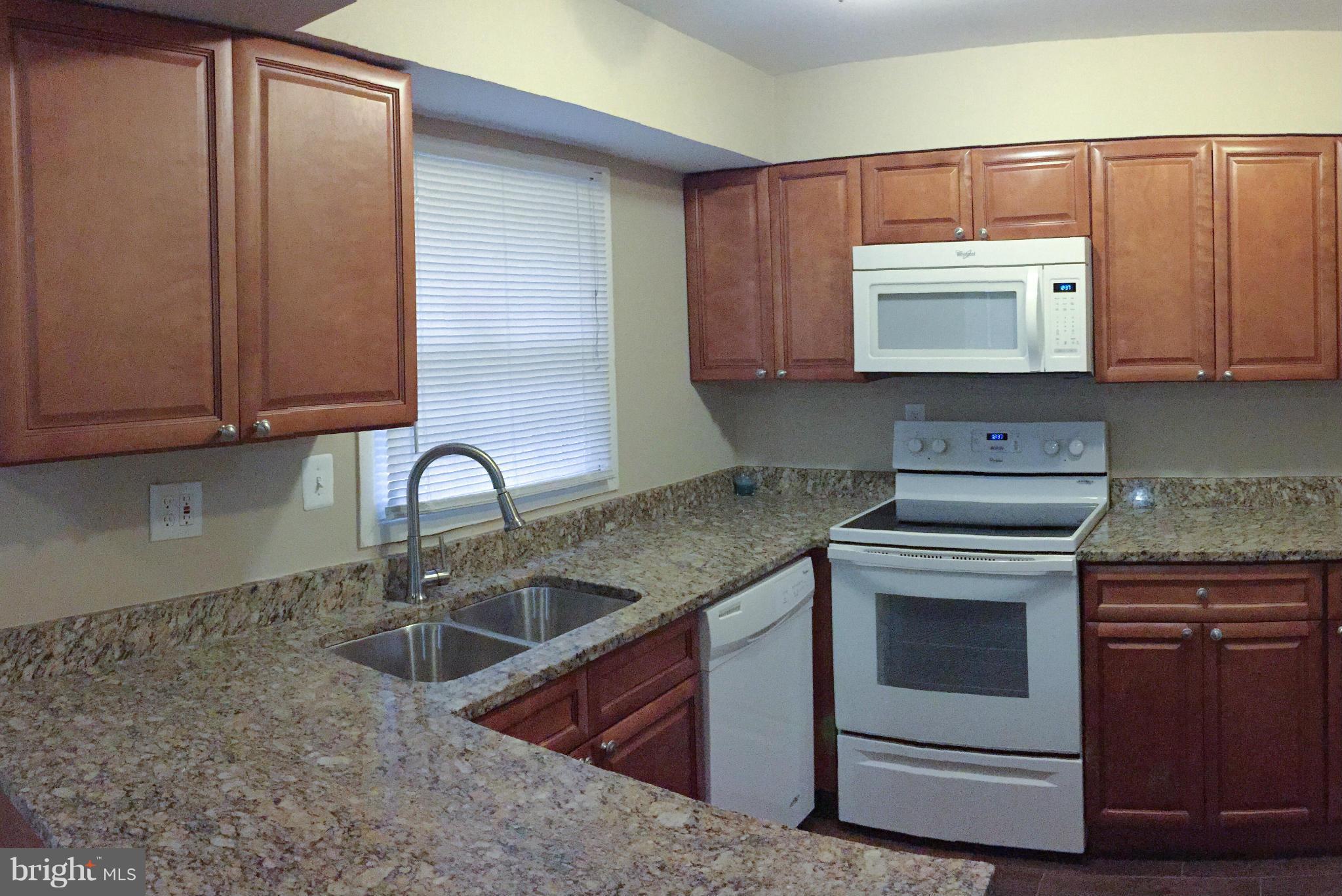 12612 Cedarbrook Lane Laurel, MD 20708 - Photo 5 of 22 a kitchen with stainless steel appliances granite countertop a sink stove and cabinets