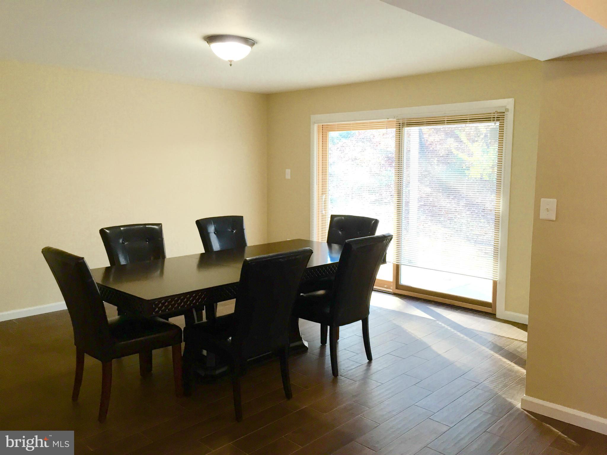 12612 Cedarbrook Lane Laurel, MD 20708 - Photo 10 of 22 a view of a dining room with furniture and wooden floor