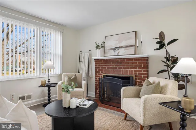 a living room with furniture a fireplace and window