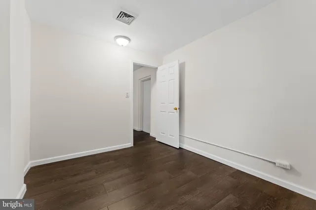 an empty room with wooden floor