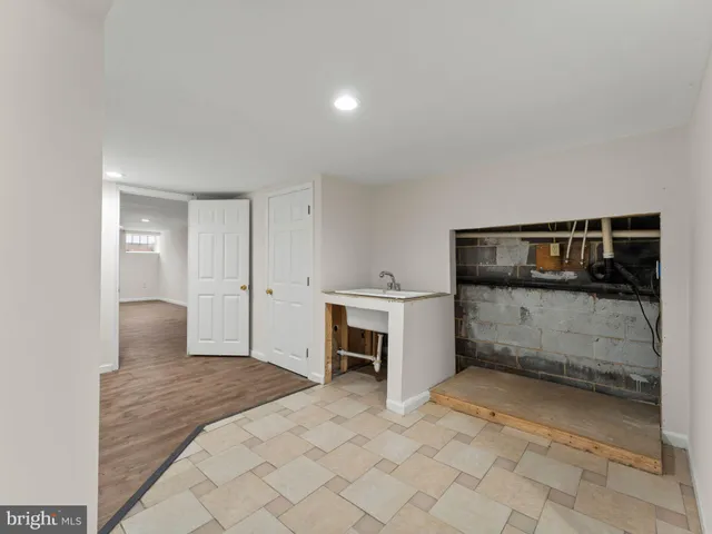 a bedroom with a bed and a sink