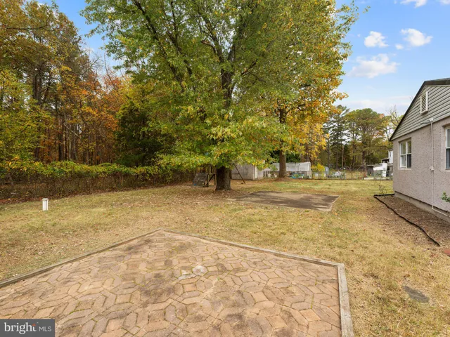 a view of yard with swimming pool and seating space