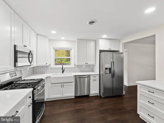a kitchen with a refrigerator and a sink
