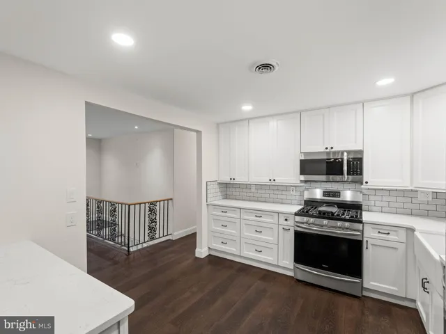 a kitchen with granite countertop a stove and a sink