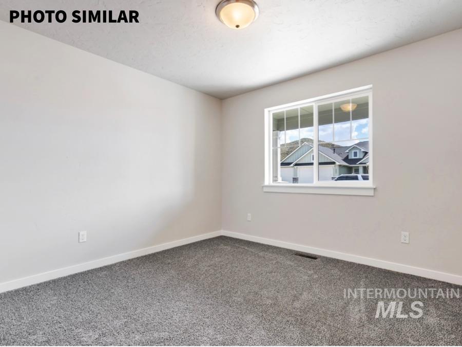 925 Twilight Weiser, ID 83672 - Photo 22 of 31 Spacious room featuring neutral carpeting, light neutral wall paint, and white baseboards