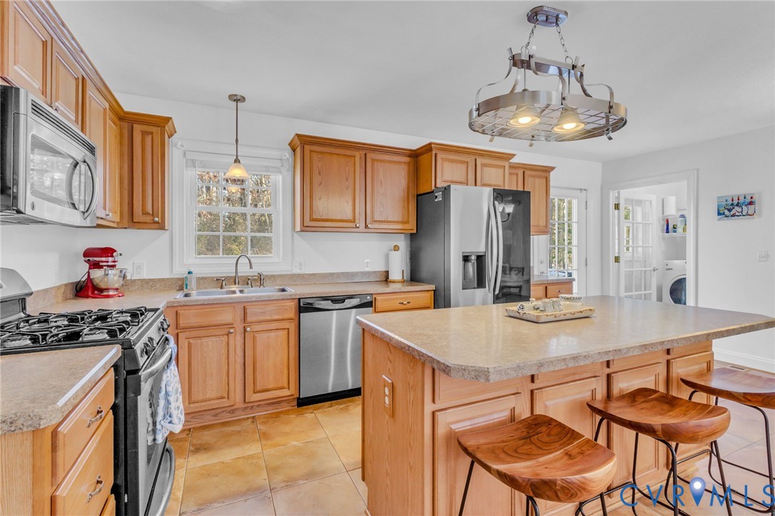 43 Ruddy Duck Road Heathsville, VA 22473 - Photo 7 of 46 a kitchen with stainless steel appliances granite countertop a sink stove and refrigerator