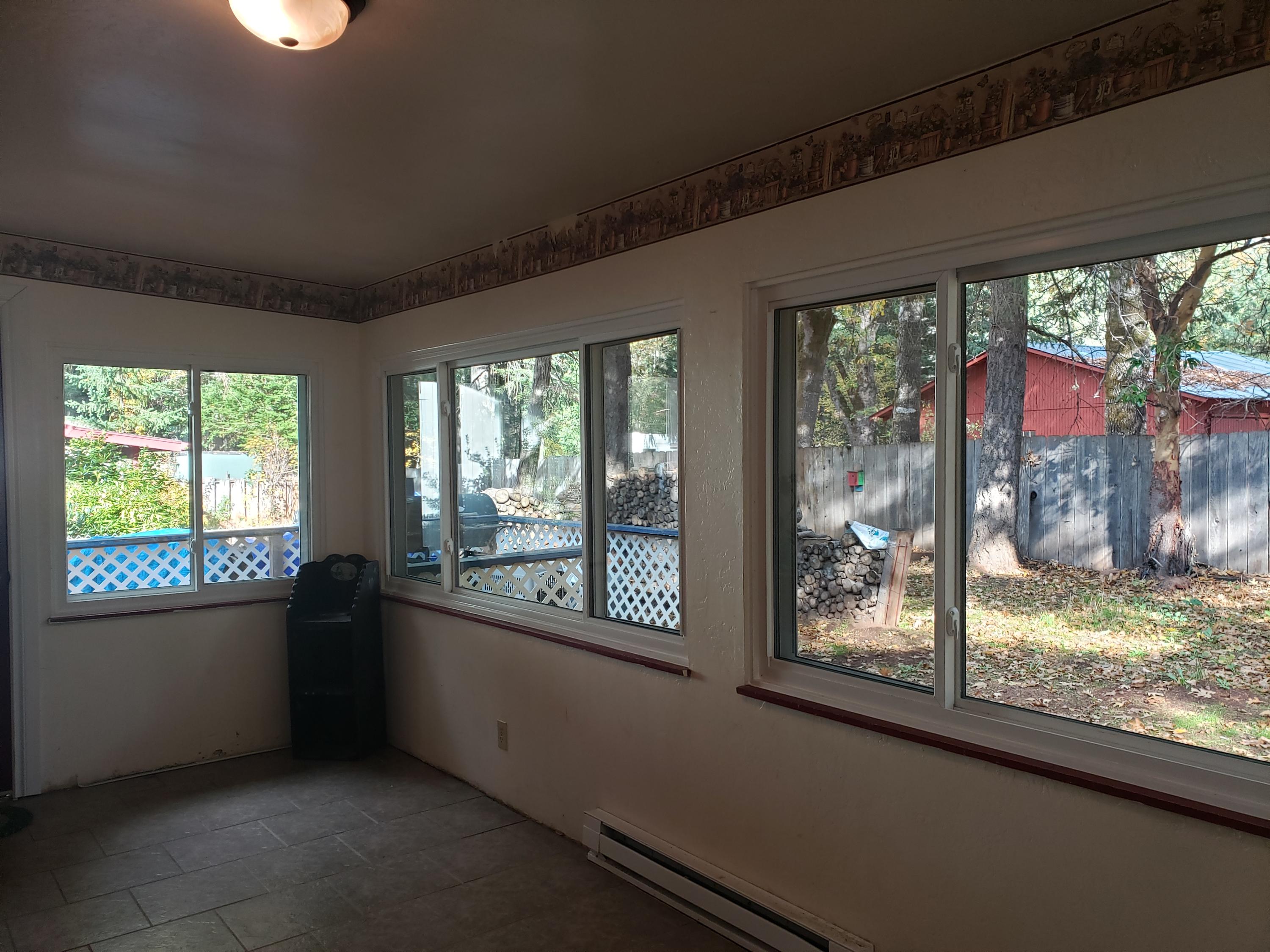 217 Shadowbrook Drive Cave Junction, OR 97523 - Photo 20 of 25 New Vinyl window 4 in enclosed sun room off of livingroom. Installed 11/04/2020