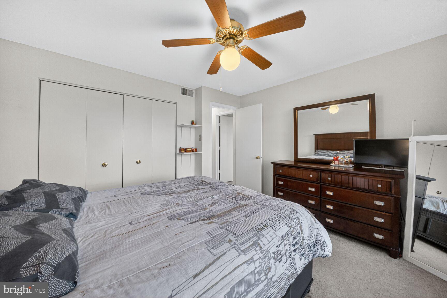 14901 McKisson Court, Unit 7CC Silver Spring, MD 20906 - Photo 13 of 34 a bedroom with a bed and a mirror on dresser