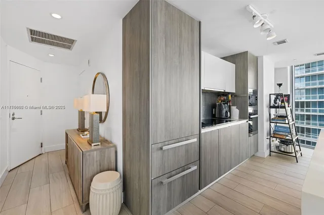 a kitchen with refrigerator and cabinets