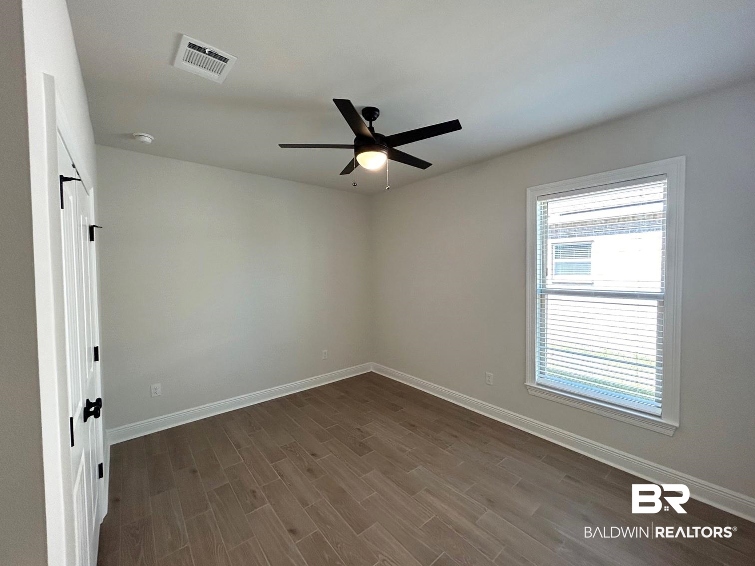 872 Sumter Loop Foley, AL 36535 - Photo 15 of 18 Empty room with hardwood / wood-style floors and ceiling fan