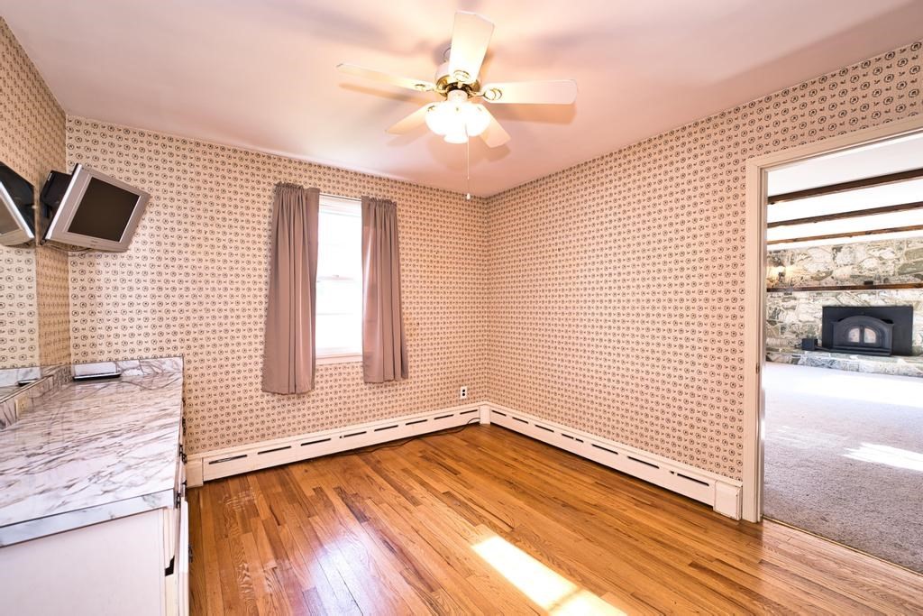 222 Blossom Road Westport, MA 02790 - Photo 15 of 37 a view of a livingroom with wooden floor and a ceiling fan
