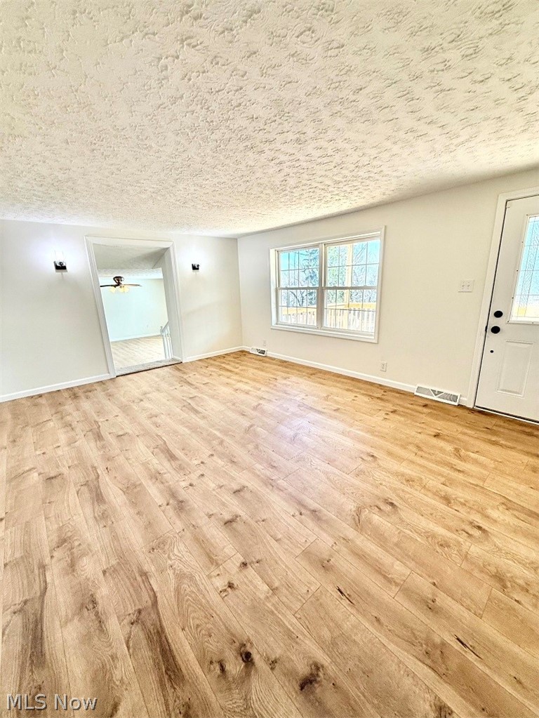 144 Aberdeen Road Steubenville, OH 43953 - Photo 16 of 34 Unfurnished living room with light wood finished floors and a textured ceiling