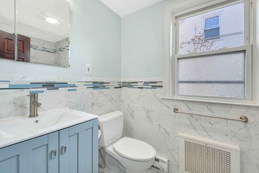 10 Middle Street, Unit 10 Newton, MA 02458 - Photo 12 of 19 a bathroom with a toilet sink and mirror