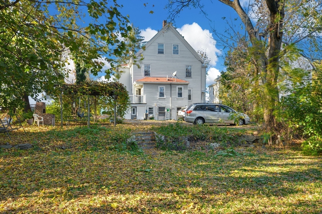 10 Middle Street, Unit 10 Newton, MA 02458 - Photo 17 of 19 a front view of a house with a yard