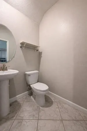 a white toilet sitting next to a bathroom sink