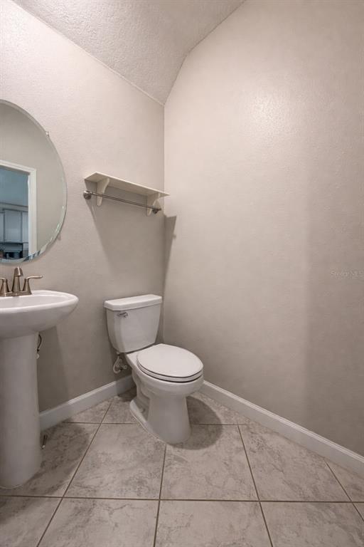 25118 Lambrusco Loop Lutz, FL 33559 - Photo 13 of 26 a white toilet sitting next to a bathroom sink