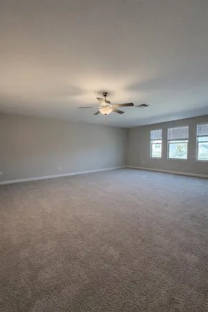 a view of empty room with window and fireplace