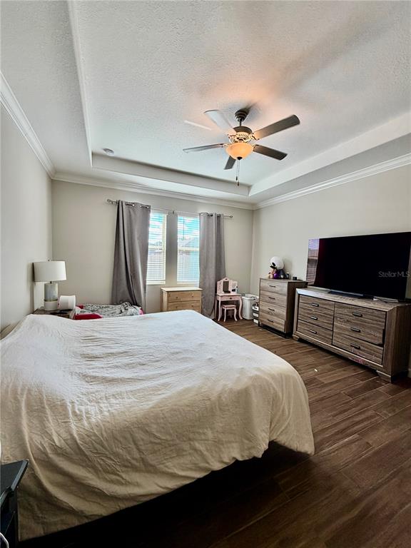 25118 Lambrusco Loop Lutz, FL 33559 - Photo 17 of 26 a bedroom with bed and a chandelier