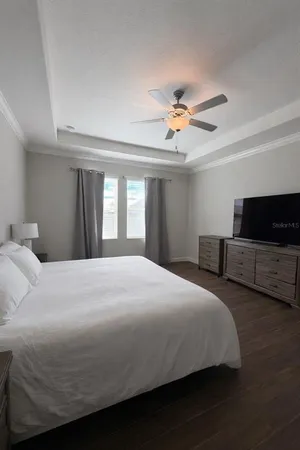 a bedroom with a bed and a chandelier