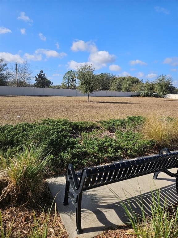 25118 Lambrusco Loop Lutz, FL 33559 - Photo 24 of 26 a view of a lake with a table and chairs