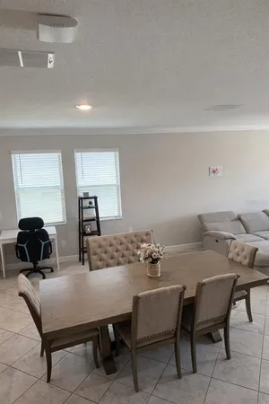 a dining room with furniture and window