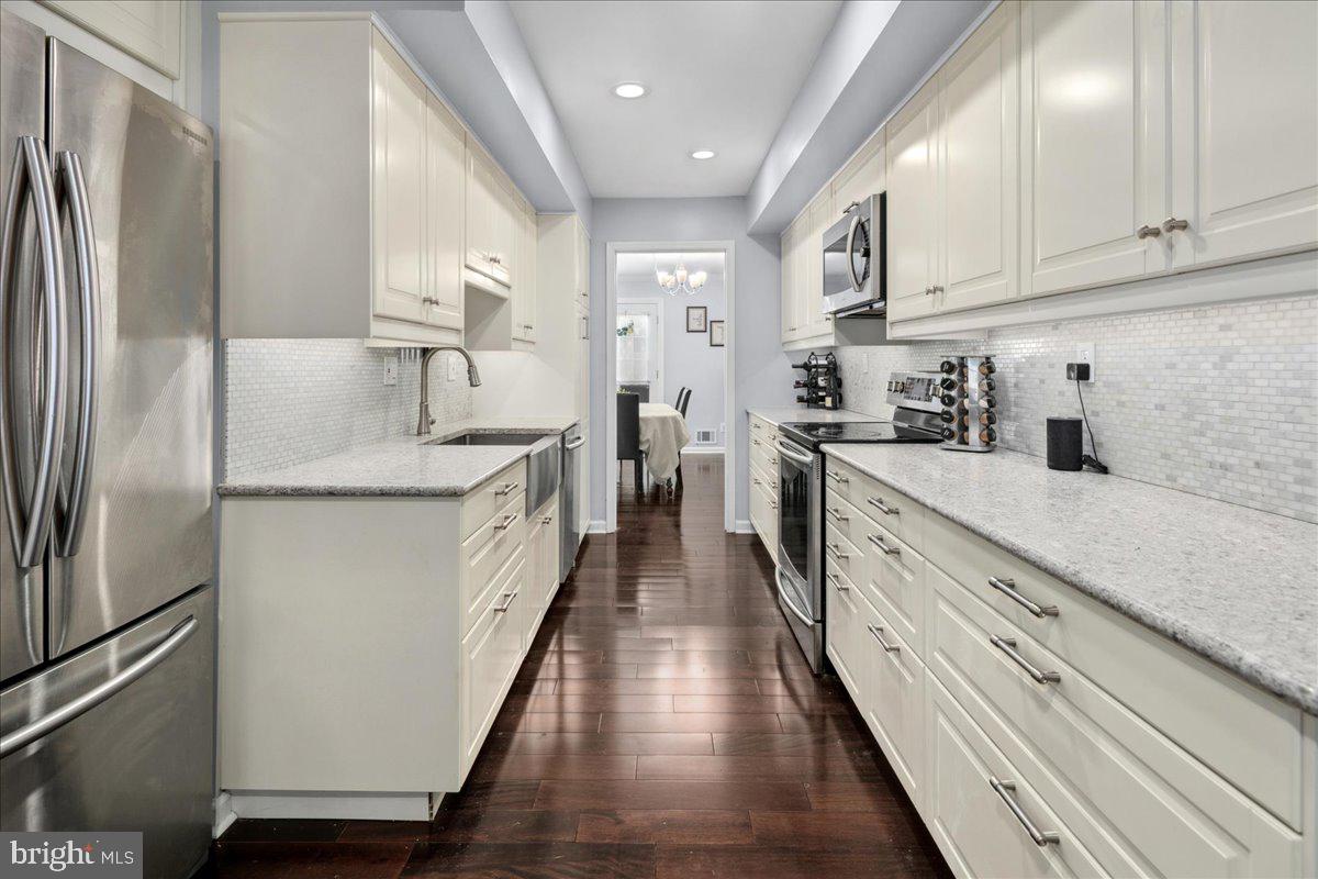 9623 Blake Lane Fairfax, VA 22031 - Photo 16 of 60 a white kitchen with stainless steel appliances