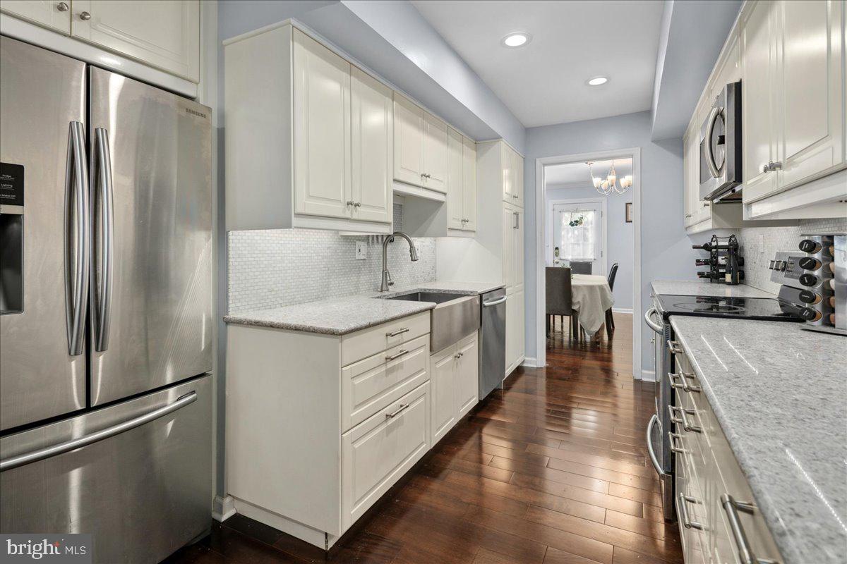 9623 Blake Lane Fairfax, VA 22031 - Photo 18 of 60 a kitchen with stainless steel appliances granite countertop a refrigerator and a stove