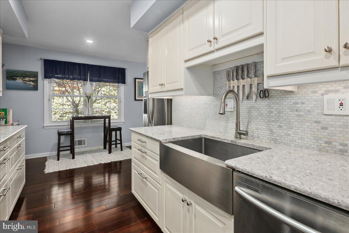 9623 Blake Lane Fairfax, VA 22031 - Photo 21 of 60 a kitchen with kitchen island a large counter top space appliances and a window