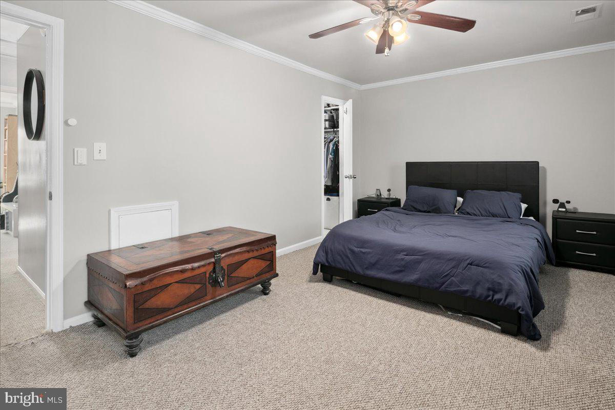 9623 Blake Lane Fairfax, VA 22031 - Photo 27 of 60 a spacious bedroom with a bed and ceiling fan