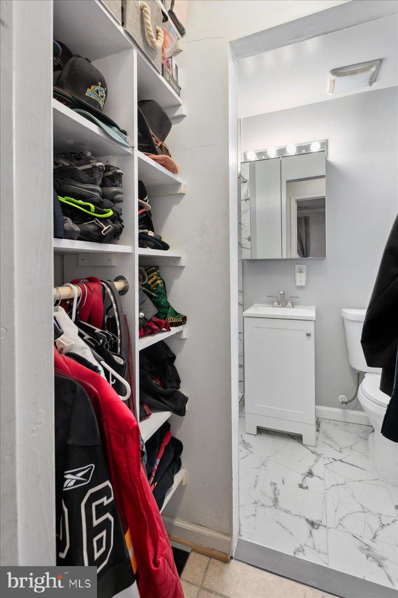9623 Blake Lane Fairfax, VA 22031 - Photo 29 of 60 a view of walk in closet with clothes and shoes