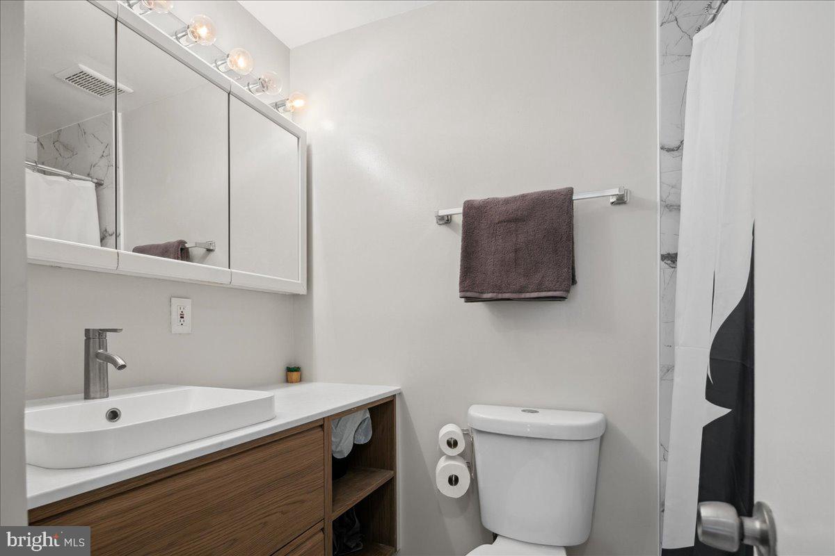 9623 Blake Lane Fairfax, VA 22031 - Photo 36 of 60 a bathroom with a toilet sink and mirror