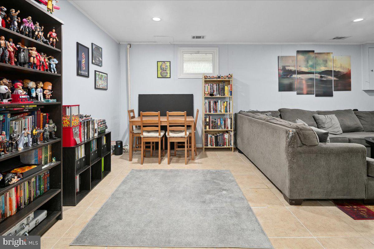 9623 Blake Lane Fairfax, VA 22031 - Photo 42 of 60 a living room with furniture a bookshelf and a flat screen tv