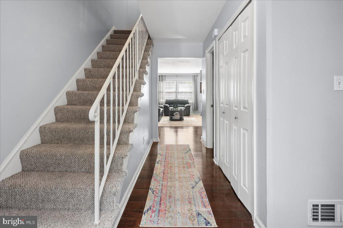 9623 Blake Lane Fairfax, VA 22031 - Photo 5 of 60 a view of a hallway with wooden floor and staircase