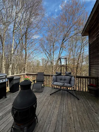a view of couches on the deck and a backyard