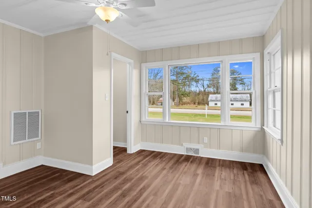 wooden floor in an empty room with a window