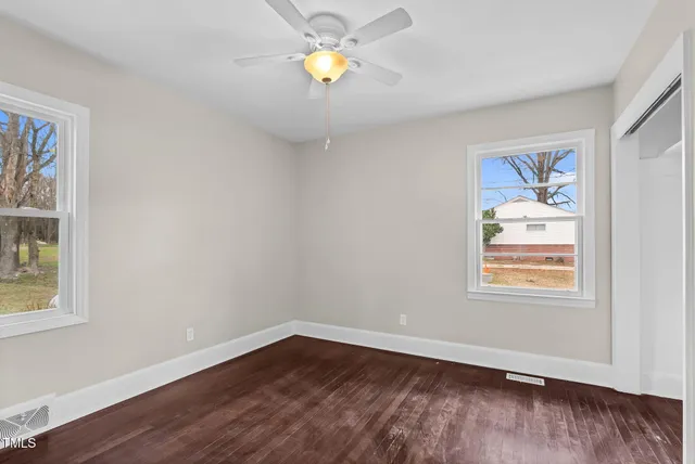 wooden floor in an empty room with a window