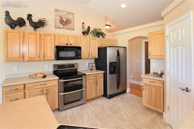 12010 Rio Secco Road Peyton, CO 80831 - Photo 4 of 36 Work your magic around this well laid out open kitchen with double oven, vaulted ceilings and recessed lighting