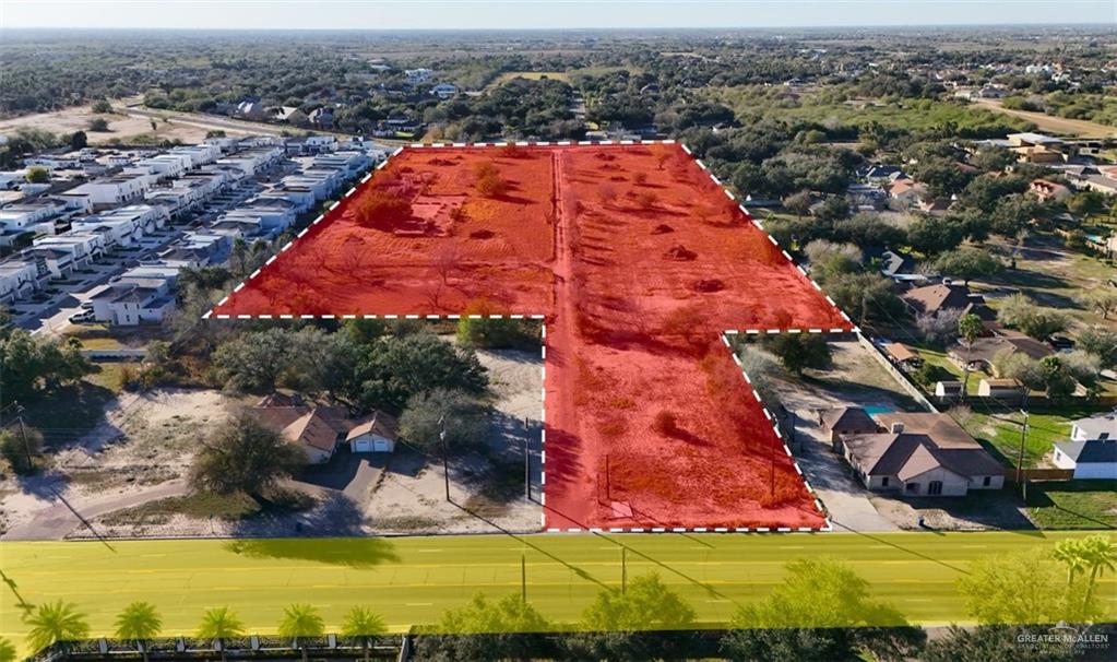an aerial view of residential houses with yard